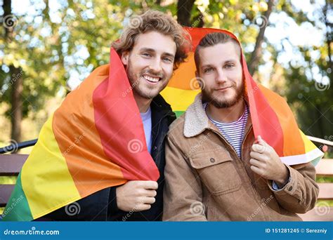 happy gay couple with rainbow lgbt flag in park stock image image of rights park 151281245