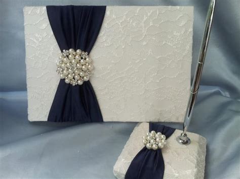 With the evolving situation and the corresponding guidelines, we have had a number of weddings and events cancelled; Navy Ivory Lace Wedding Guest Book and Pen Set Ivory Bridal