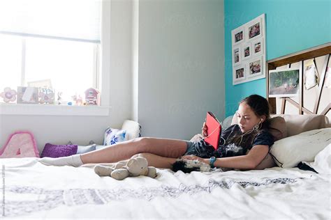 Teen Girl On Electronic Device By Stocksy Contributor Ronnie Comeau Stocksy