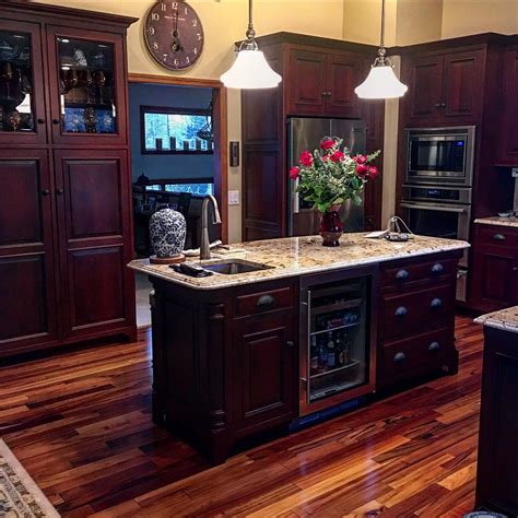 To create a warm backdrop that will make the natural wood tones of your maple cabinets fade into the wall color without painting the cabinets themselves, opt for a burnt terracotta color like firenze by benjamin moore. Dark cabinets with light countertops. Kitchen island ...