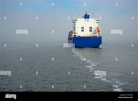 The Blue Container Ship Cruising At Sea Stock Photo Alamy