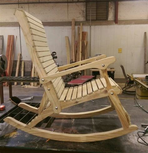 A Wooden Rocking Chair Sitting On Top Of A Workbench In A Shop Or Workshop