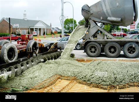 Cement Truck Pouring Cement For A New Concrete Road Stock Photo Alamy