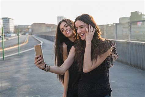 Two Friends Taking A Selfie In The City By Gic For Stocksy United Selfie Photo Couple Photos