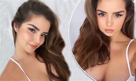 Demi Rose Flaunts Her Ample Cleavage In A Plunging White Dress For Sexy