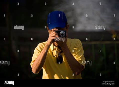 A Blind Photographer Takes Pictures During A Photography Workshop For