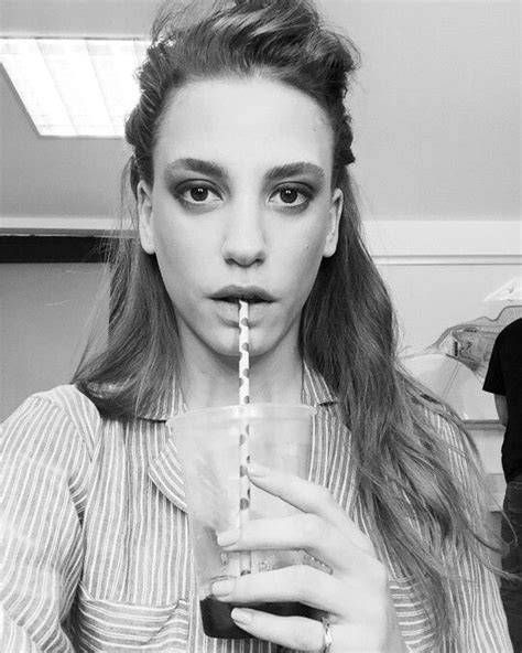A Woman Holding A Straw In Her Mouth