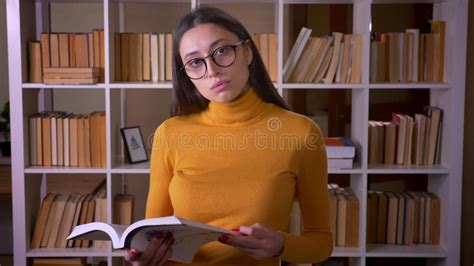 Portrait Of Brunette Female Teacher In Glasses Posing Into Camera And
