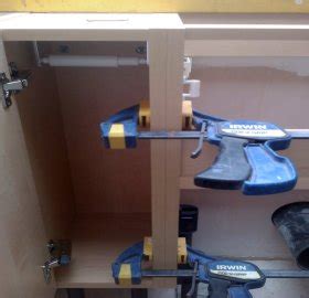 Check to make sure cabinet is plumb. How to install kitchen cabinets wall and floor