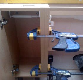 Attack clamping tasks from three sides. How to install kitchen cabinets wall and floor