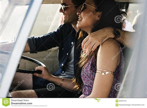 Couple Driving A Car Traveling On Road Trip Together Stock Photo
