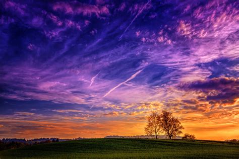 1125x2436 Resolution Green Grass Field Under Blue And Orange Clouds