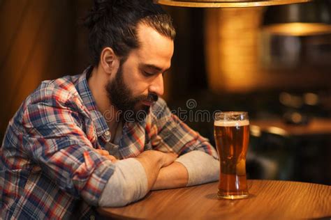 Unhappy Lonely Man Drinking Beer At Bar Or Pub Stock Photo Image