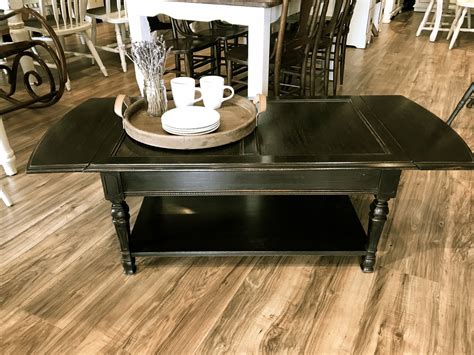 Classic moldings and plenty of shelf space make this coffee table a smart choice for transitional interiors. 8 Distressed Dark Wood Coffee Table Pictures