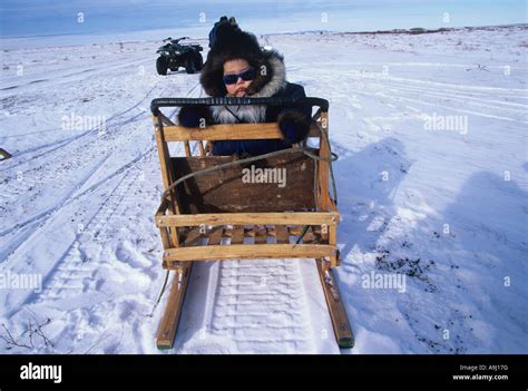Usa Alaska Mr Yupik Eskimo Alex Sampson Sits On Snowmobile Sled Outside