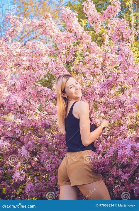 Beautiful Smiling Young Woman Near The Blossoming Spring Tree Portrait Of Pretty Blond Girl