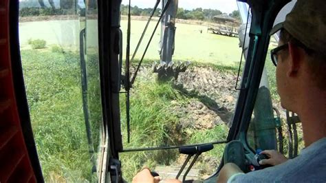 Your biggest consideration is smoking yourself out?? Dredging out a pond - YouTube