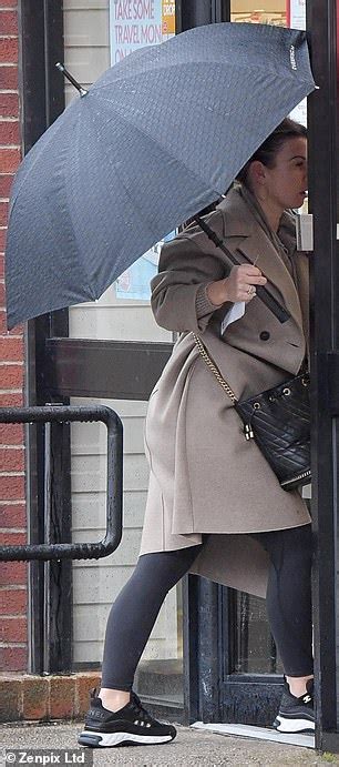 Coleen Rooney Shields Herself From Downpour As She Heads To The Post