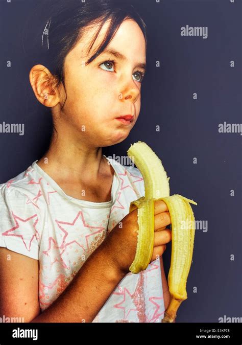 Girl Eating A Banana Stock Photo Alamy