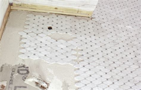 Dampen a sponge and wipe down the tumbled marble tile. cutting, grouting and sealing marble tile tips