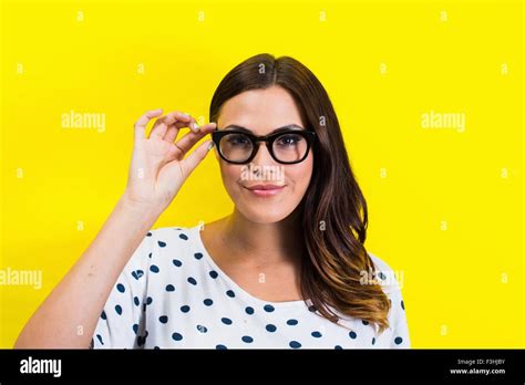 Portrait Of Young Woman Holding Eyeglasses Stock Photo Alamy