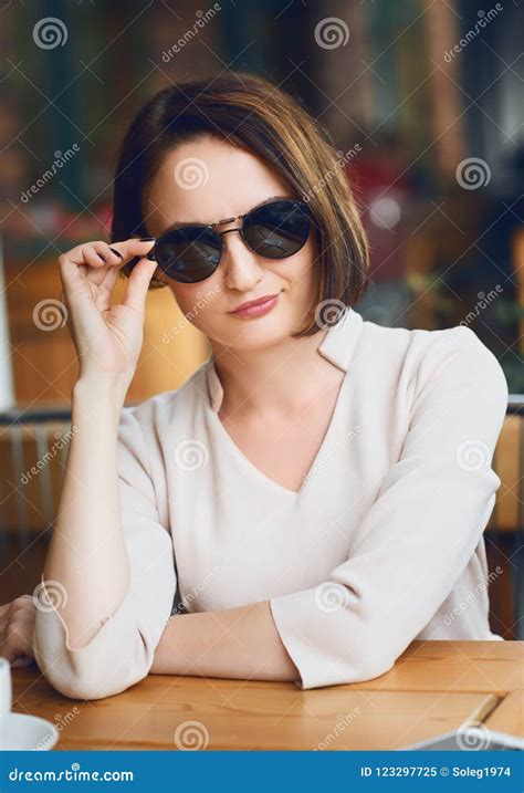 Young Woman Drinks Coffee In Cafeteria And Posing With Sunglasses Stock Image Image Of Modern