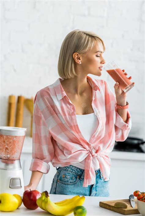 blonde woman drinking tasty smoothie in kitchen stock image image of diet drinking 192548241