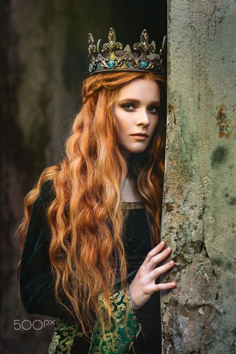 ginger queen near the castle red haired woman in a green medieval dress near the castle