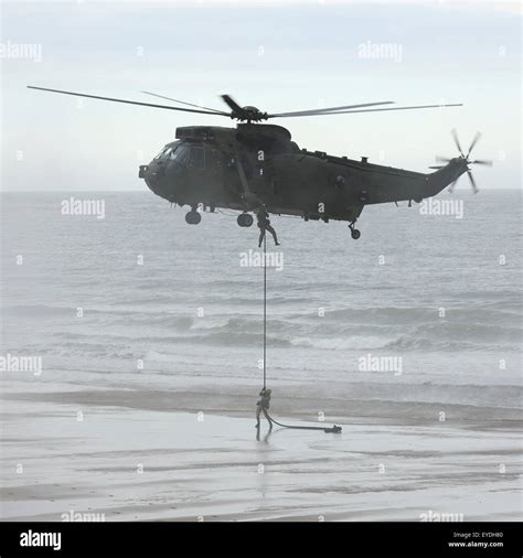 A Royal Navy Sea King Mk4 Helicopter Performs A Beach Assault At