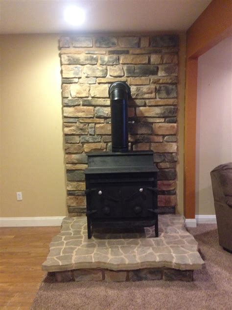 It creates a stylish veneer, whether building a contemporary or traditional. Wood stove and neutral stone veneer. | Wood stove, Stone ...