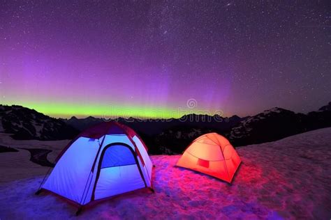 Aurora Borealis And Tents On Snow Mountain Royalty Free Stock Photos