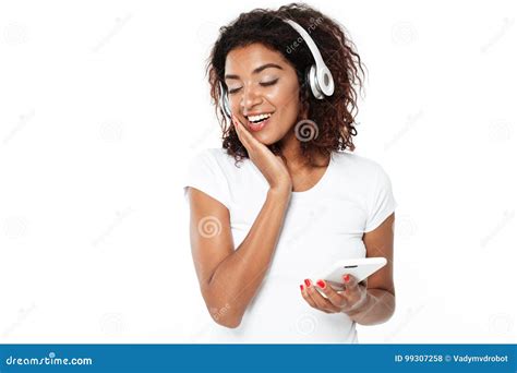 Happy Young African Lady Listening Music In Headphones Stock Photo