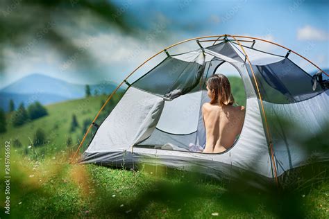Back View Of Beautiful Naked Woman Traveller Sitting In Tent Enjoying