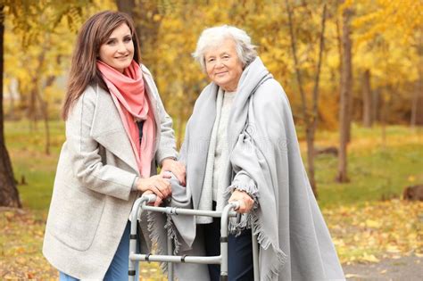 Senior Woman With Walking Frame And Young Caregiver Stock Photo Image