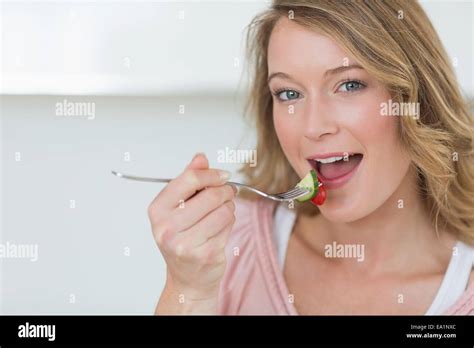 Woman Eating Salad With Fork Stock Photo Alamy