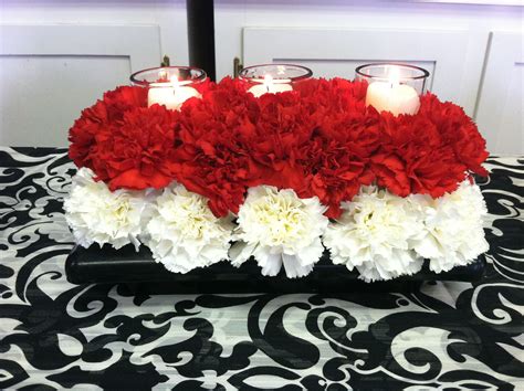 Red And White Carnation Centerpiece With Candles Perfect For Weddings