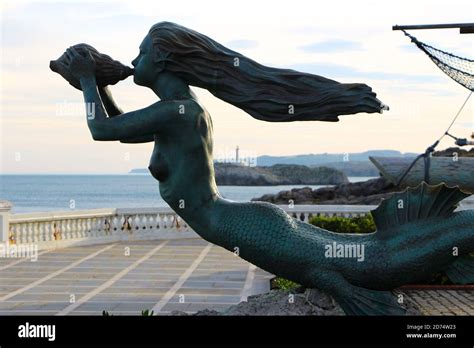 Bronze Mermaid Sculpture With Long Flowing Hair Blowing Into A Conch
