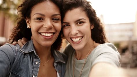 Mixed Race Girl Friends Taking Selfie And Smile Into Camera Stock Footage Video 8050528