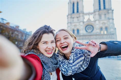 Two Young Girls Taking Selfie Near Notre Dame In Paris Goinglobal Blog