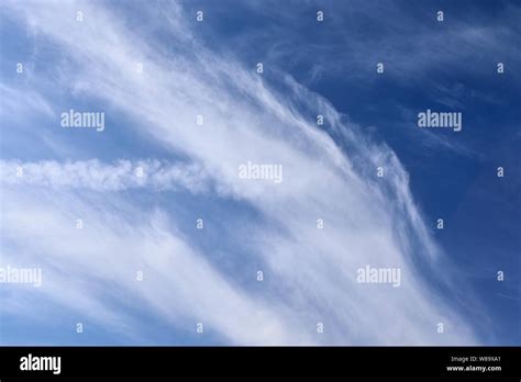 Beautiful White Cirrus Cloud Formations On A Deep Blue Sky Stock Photo