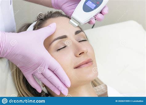 Cosmetologist Makes An Ultrasonic Cleaning Of The Face Stock Image