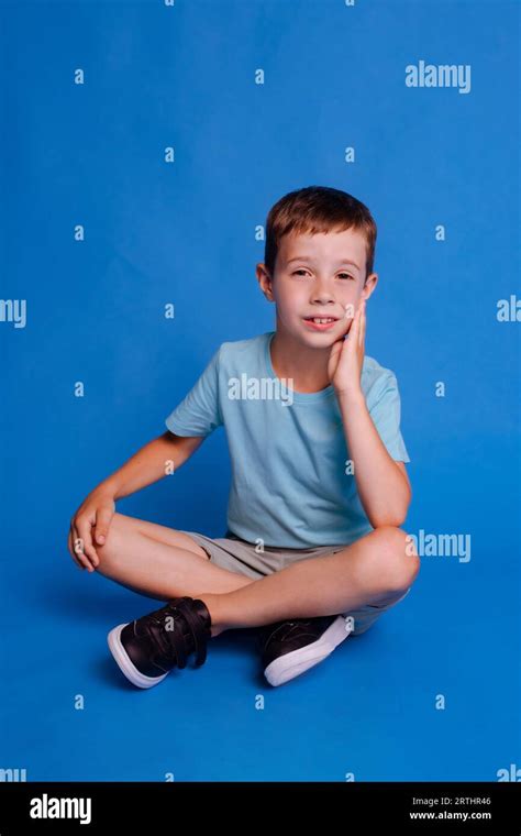 Child Boy Crossed Legs Wear Blue Mockup T Shirt Sitting Isolated Over