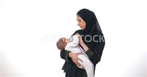 بورتريه لأم تحمل إبنها الرضيع حديث الولادة ، أم تقوم بإطعام طفلها الرضيع بإستخدام زجاجة الرضاعة