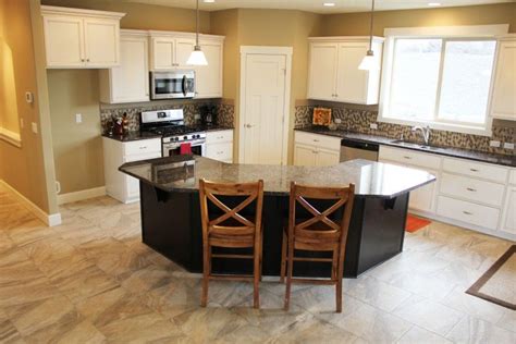 Using angled kitchen island create a space before getting in the kitchen, such as, for instance, a mudroom, to control the chaos that could come sweeping in every single day. angled kitchen island designs | Generous kitchen with ...