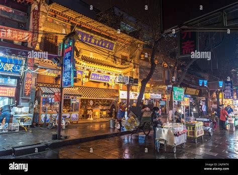 Xian China Shops And Illuminated Signboards By Night In A