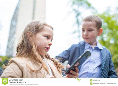 Portrait Couples Children Boy And A Girl With Phone Outdoor Small