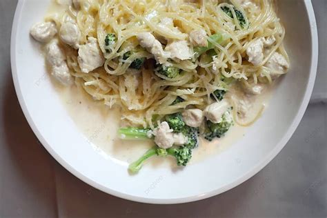 A Dish Of Broccoli Chicken Alfredo Spaghetti With Creamy White Sauce