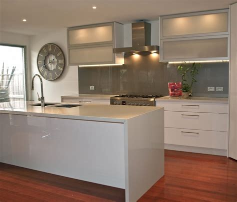 Photo of a classic galley kitchen in london with a submerged sink, shaker cabinets, beige cabinets, grey splashback, metro tiled splashback, dark hardwood flooring, an island, brown floors. Kitchen Splashbacks - Kembla Kitchens