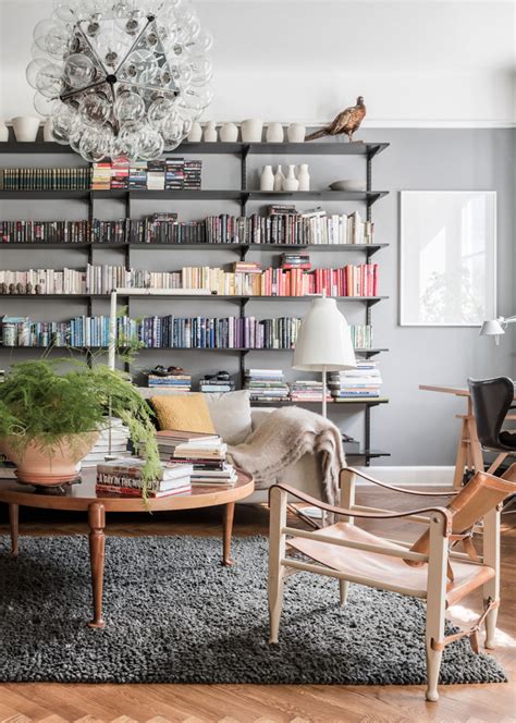 Cozy Living Room Library With Grey Walls Leather Chairs Large Bookshelf