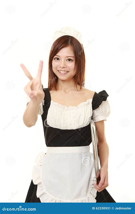 Young Japanese Woman Wearing French Maid Costume Showing A Victory Sign